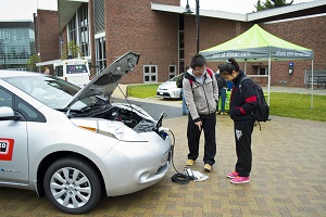 Visitors check out the charging system on the Nissan Leaf during last year’s show.