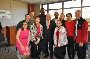Robert Kraft, center, former New England Patriots Willie McGinest and Troy Brown rear center, and Tahar El-Korchi, right, with MQP students.