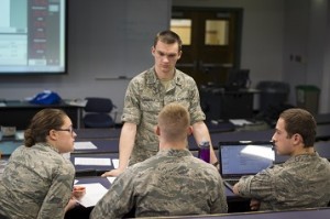 Air Force ROTC Cadet Mark Andraka confers with team members Brittany Kyer, Brian Gasco and Miles Schuler during a cybersecurity exercise that enlisted the expertise of the Air Force Research Lab in Rome, N.Y. and the 102nd Intelligence Wing at Otis Air National Guard Base on Cape Cod.