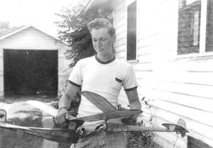 Noiles at his family home in Hudson, Mass., with a model airplane he constructed.