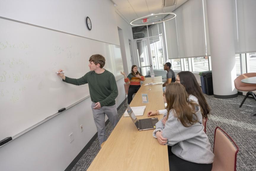 Student tutors utilizing whiteboard during tutoring session 