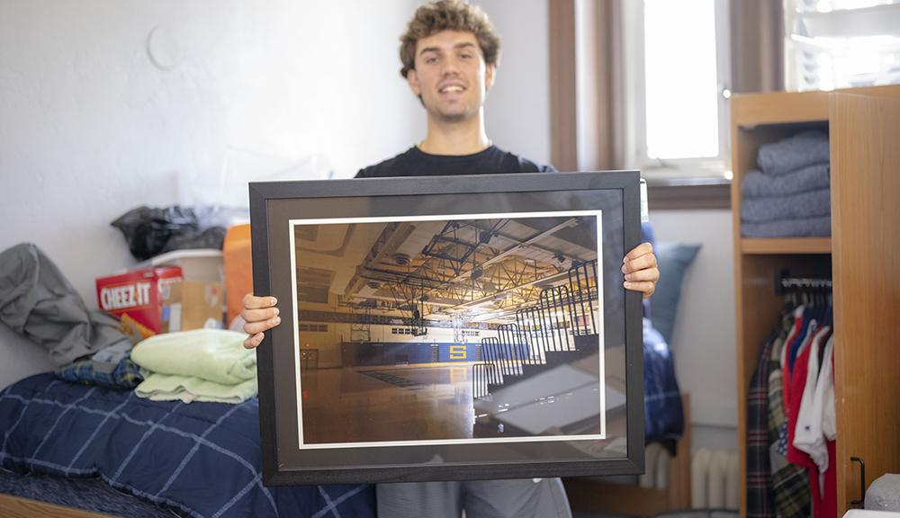 Justin Molen shows off a giant framed photo