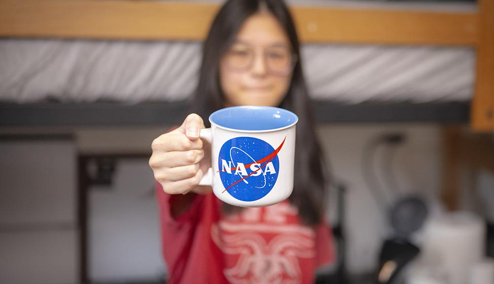 Laura Hiu shows off a NASA coffee cup
