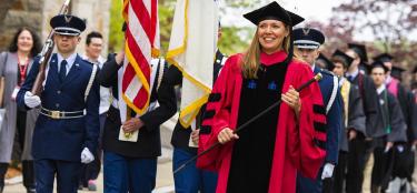 Professor Natalie Farny leading a commencement procession as winner of the Trustees’ Award for Outstanding Teaching