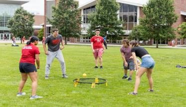 students playing spikeball on the quad
