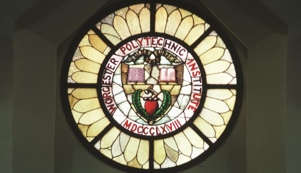 A stained glass window depicting the WPI seal