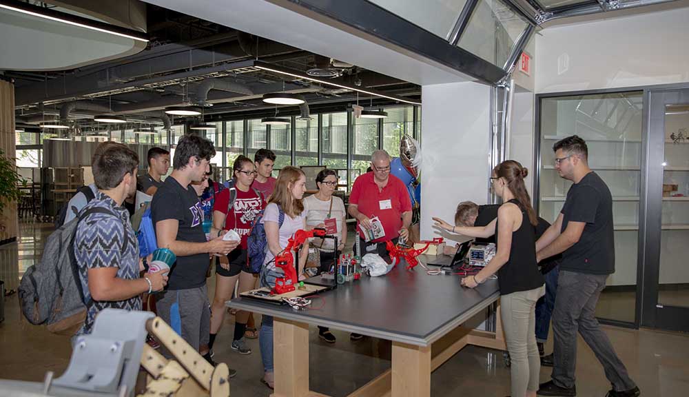 Jess McKenna and her classmates display their 3D-printed robotic cats to visitors to the Foisie Innovation Studio.