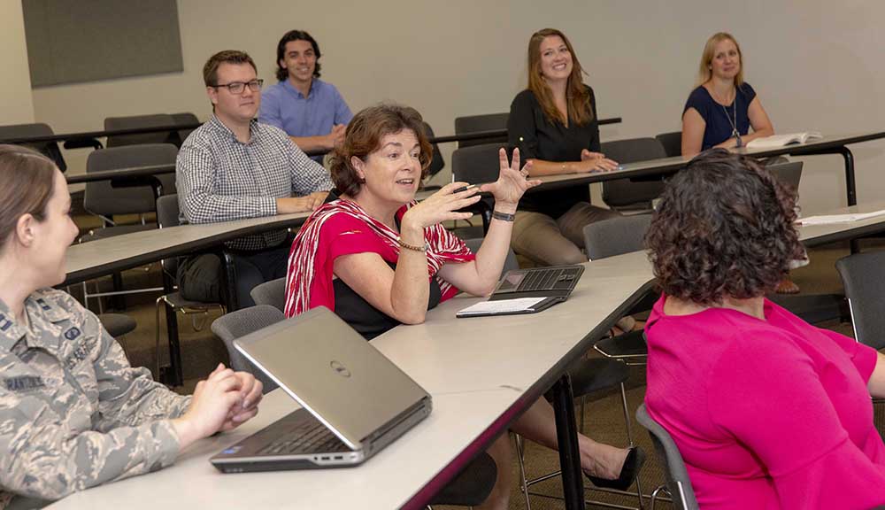 Fabienne Miller (center) discusses a concept with students during one of her classes.