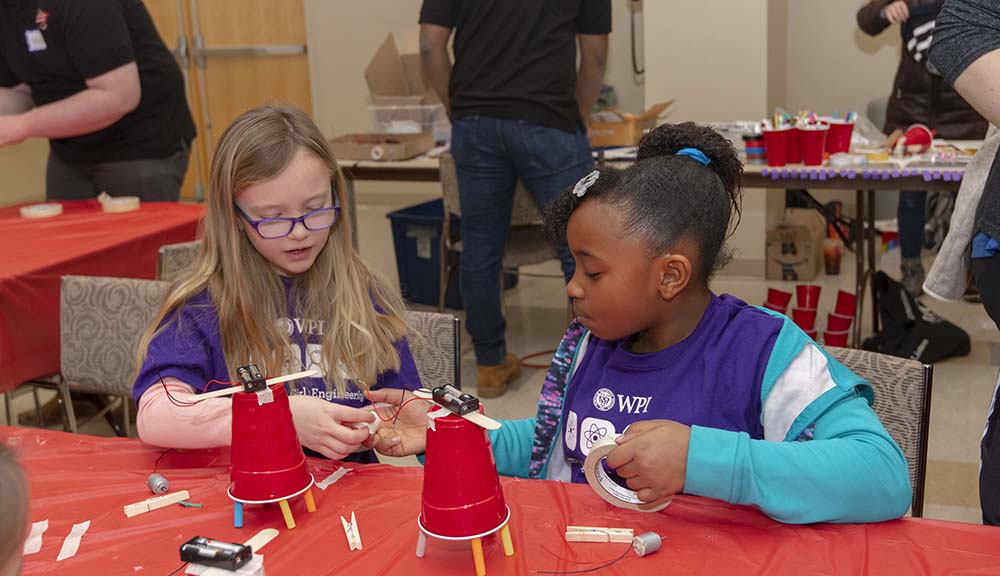 Two girls participate in a hands-on STEM activity during Introduce a Girl to Engineering Day.