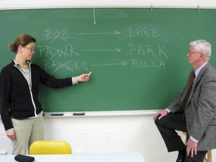 by Missouri S&T English Chair Kristine Swenson at the blackboard shows Jack Carney proper pronunciations of common words alt