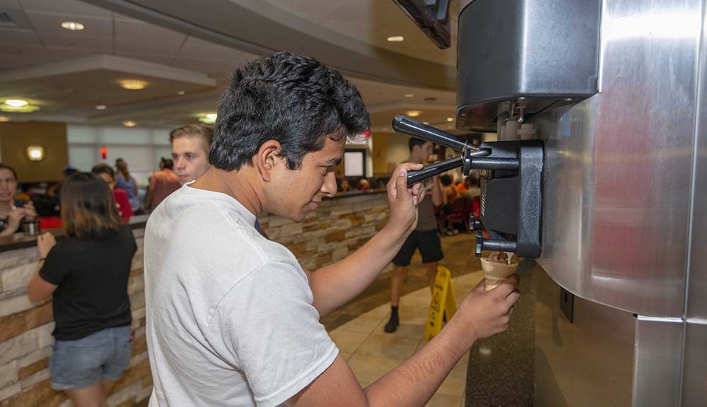 A student gets some soft-serve ice cream in Morgan Dining Hall.