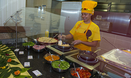 Chef cooking in a yellow uniform.