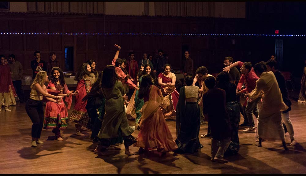 Students dance while celebrating Diwali in Alden Memorial.
