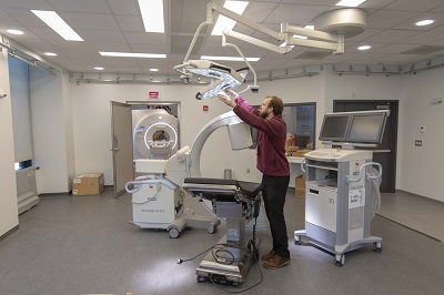 Chris Nycz, a WPI graduate student and research scientist, sets up the PracticePoint operating room. alt