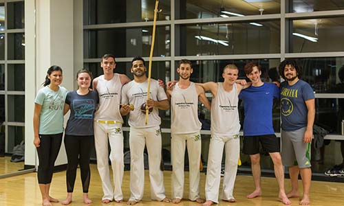 SOMA members take a break from Capoeira practice for a quick photo. alt