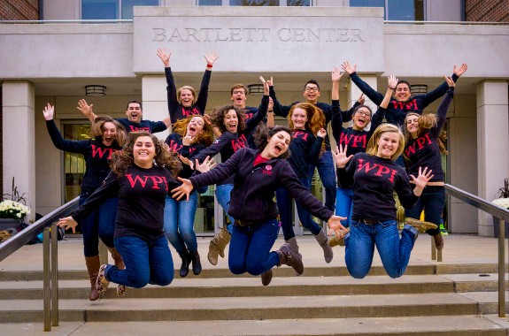 club of students jumping off of the stairs of the Bartlett Center