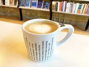 Image of coffee cup with text from Ada Limon's poem  alt
