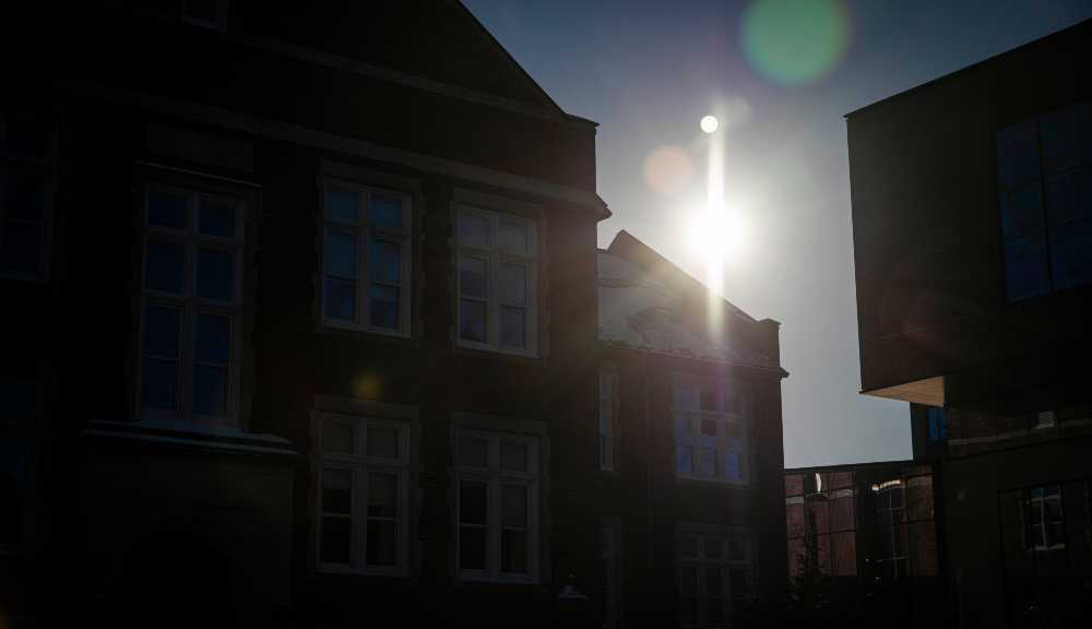 A photo of buildings on campus against the sunlight.