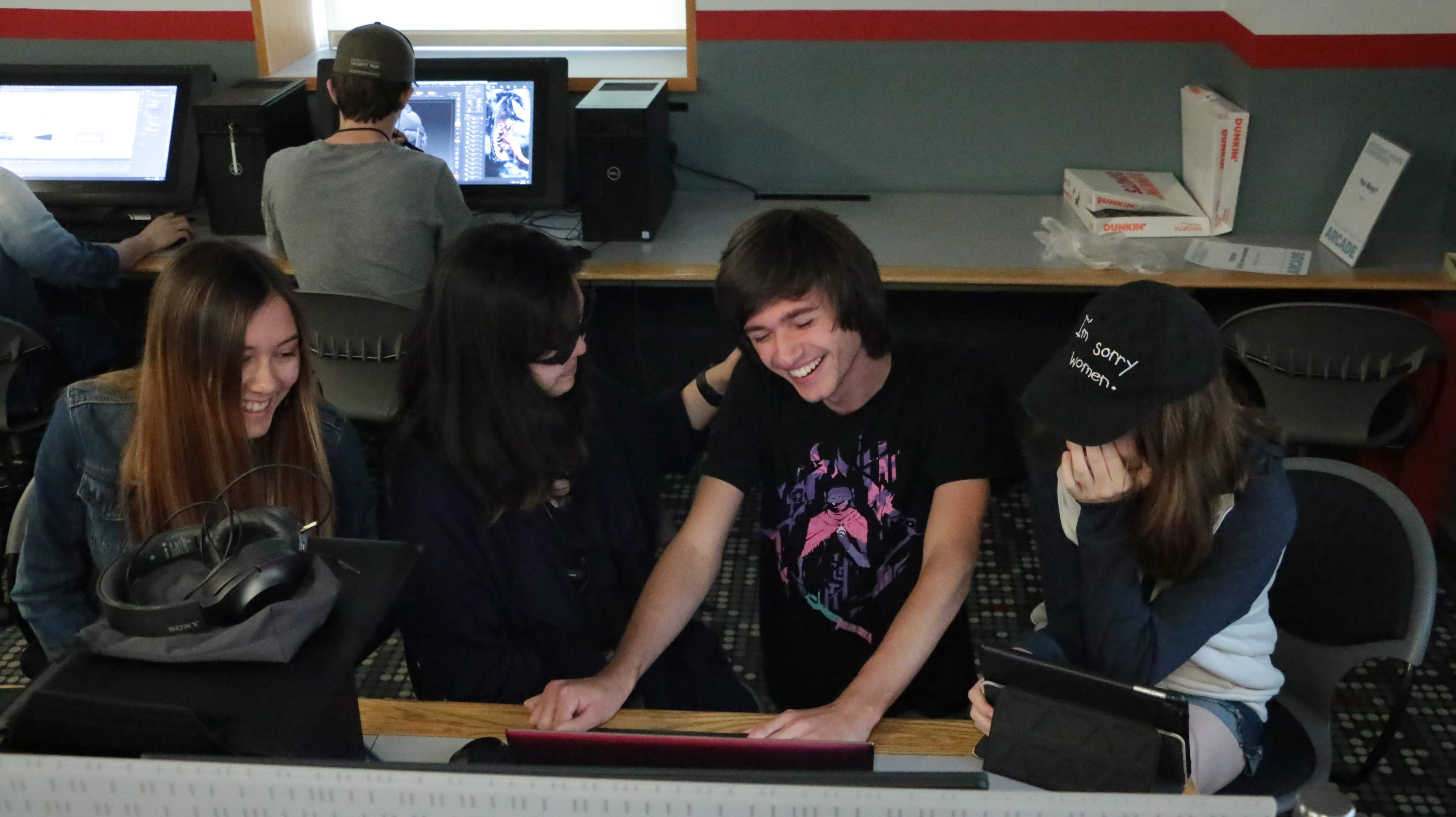 IMGD students gathered around a computer in a Fuller lab
