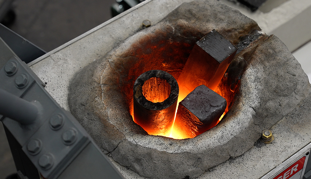 Preheating the waste steel parts to remove residue. alt