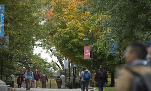 Students walking across campus on a fall day