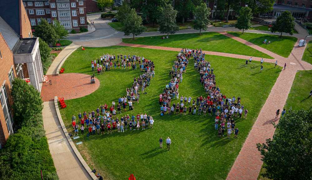Members of the Class of 2024 arrange themselves in a giant "24" in an aerial photo over the Quad.