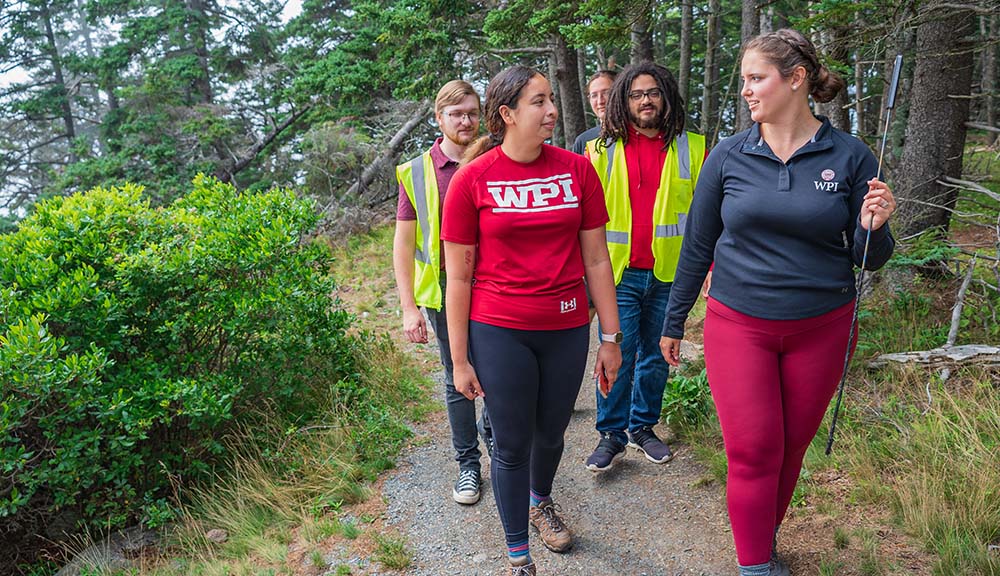 Students walk along a trail together in Acadia National Park.