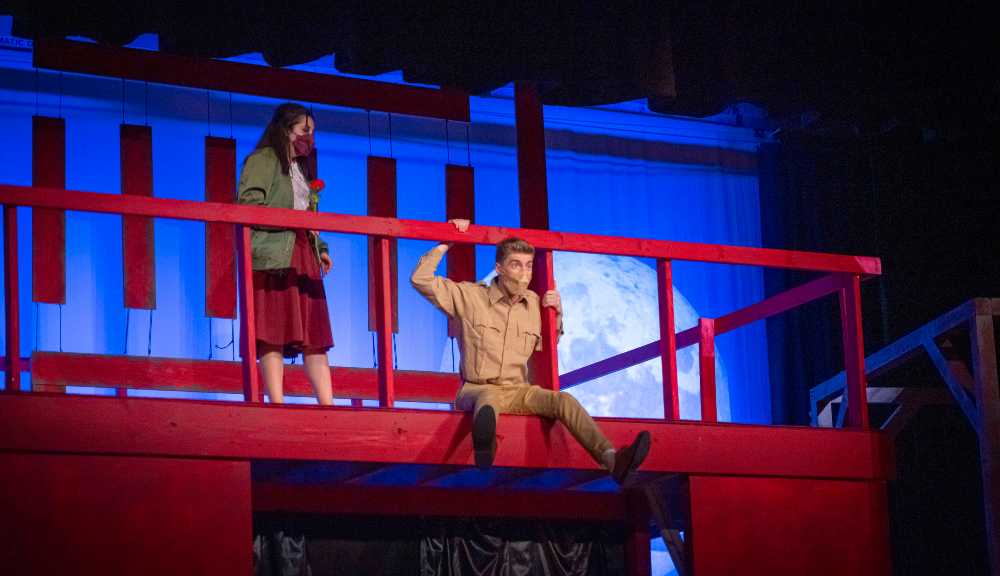 Two student performers during a performance of the musical "Dogfight."