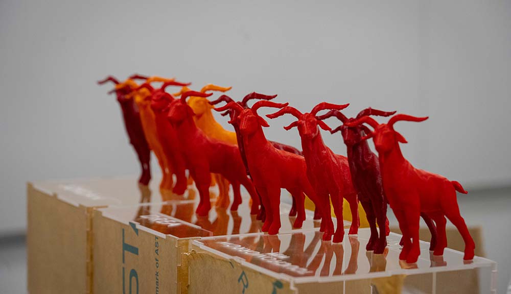 A row of red 3D-printed Gompeis.