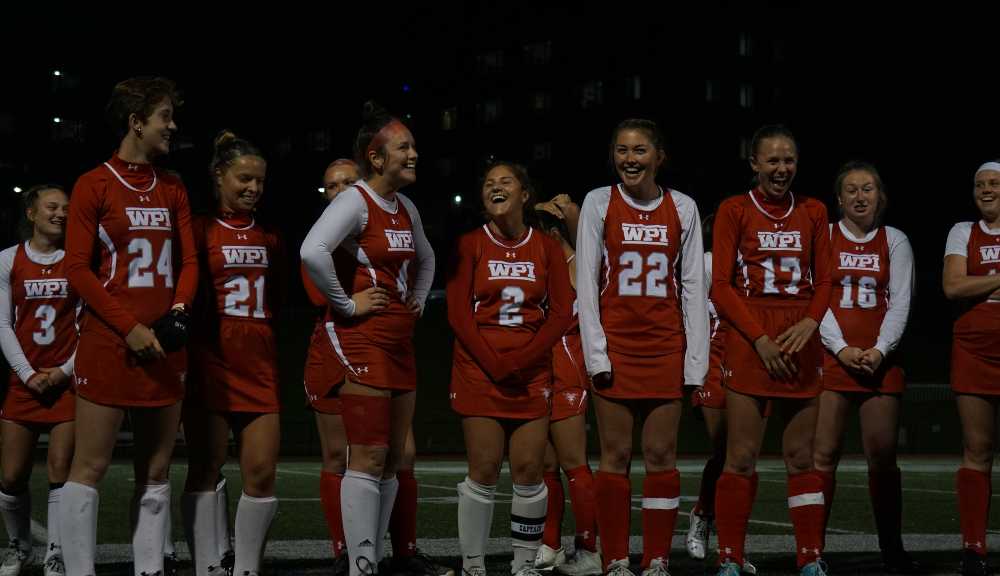 Members of the field hockey team share a laugh before the Senior Night game.