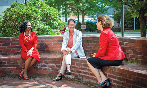 Dean Debora Jackson and Dean Mimi Sheller sit down with President Laurie Leshin outside on WPI campus