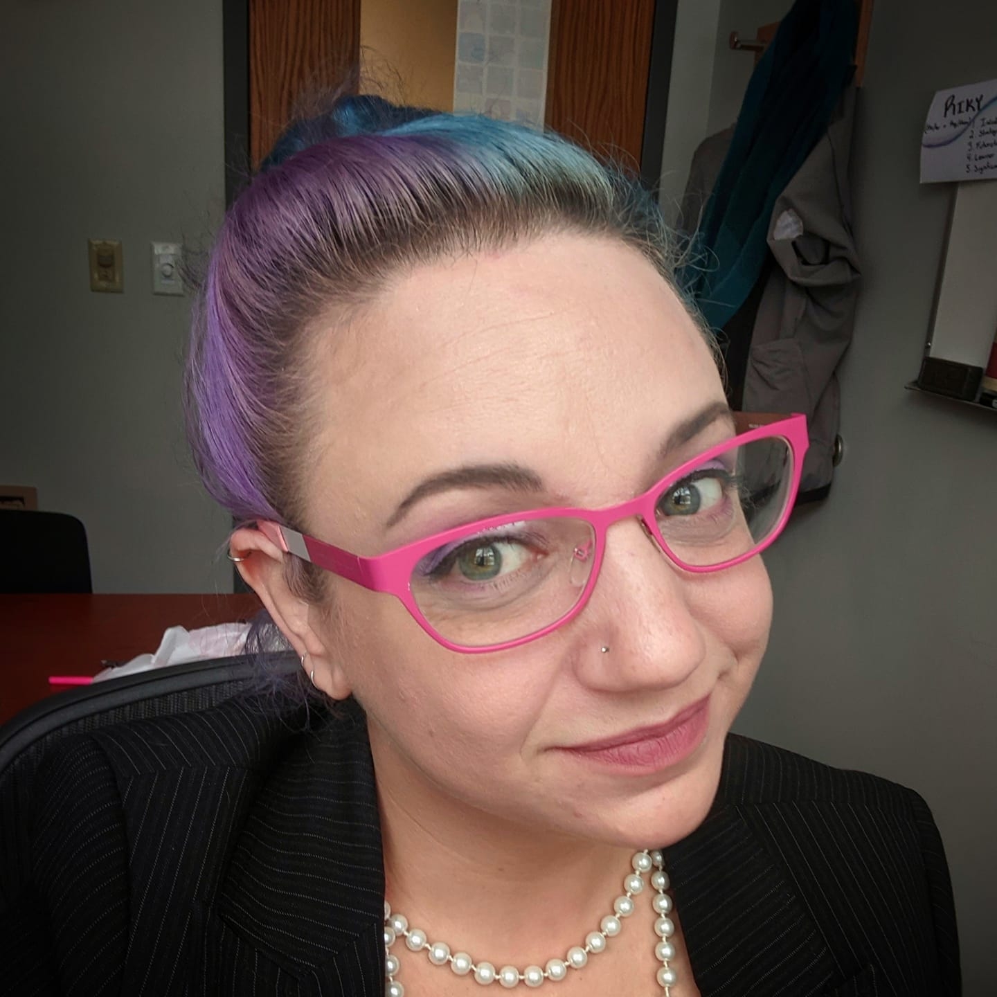 Erika Riky Hanlan with colorful hair and glasses