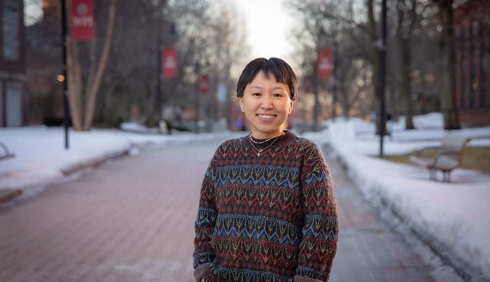 Min Wu smiles for the camera outside near the center of campus.