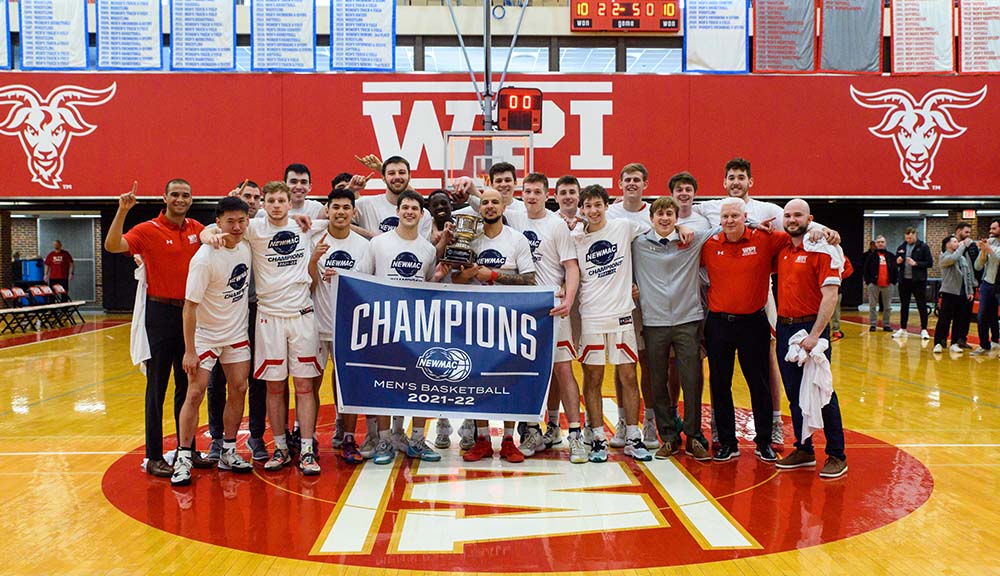 The men's basketball team gathers for a photo on the court following their championship victory.