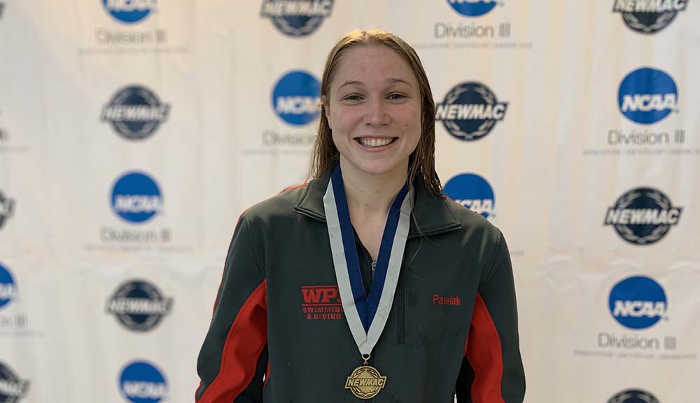 Katherine Pawlak ’22 smiles while wearing her new medal.