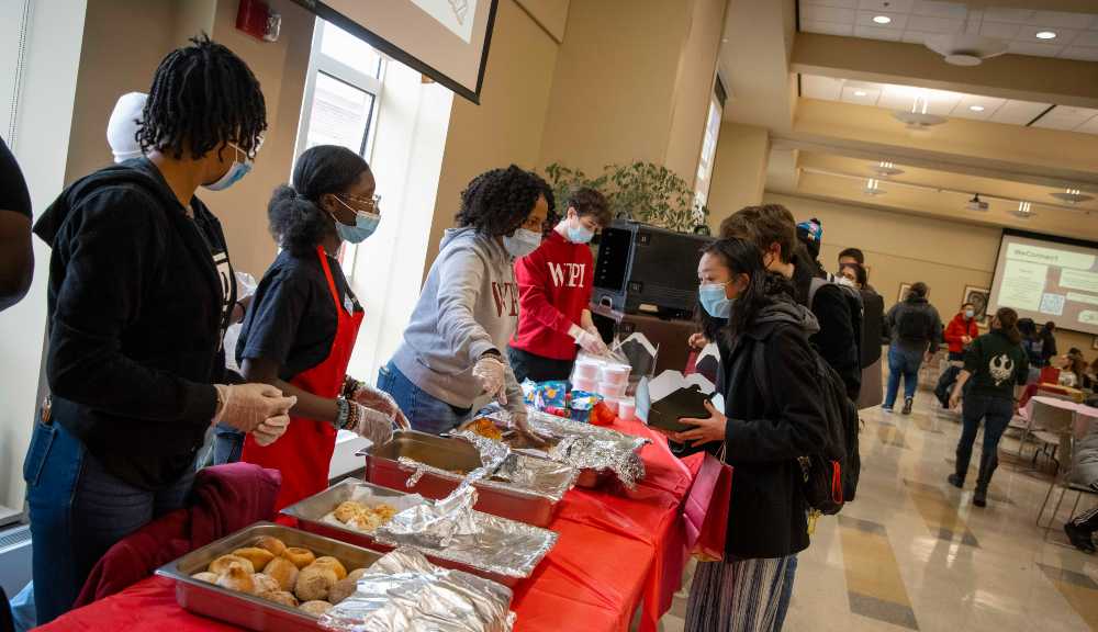 DoughBoyz crew members serve breakfast to WPI students in the Odeum.