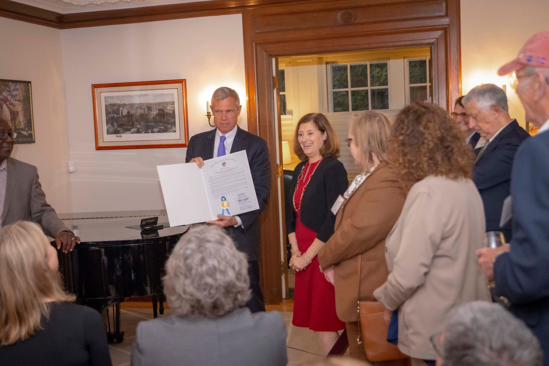 State Representative John Mahoney presents President Leshin with a proclamation from the Massachusetts House of Representatives alt