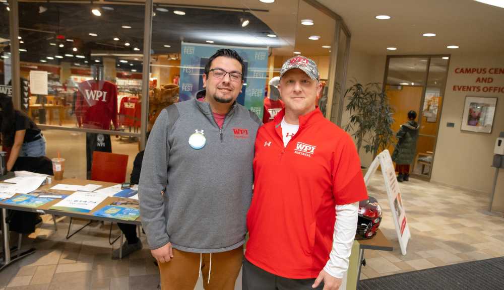 Frank Almeida and Chris Robertson pose for a photo during the football team's Be the Match marrow donor drive.