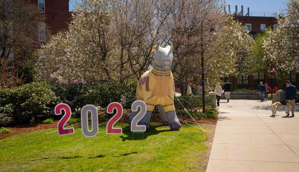 Cardboard cutouts of the numbers "2022" next to a giant inflatable Gompei.