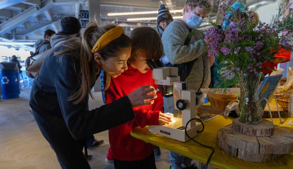 TouchTomorrow visitors look under a microscope at Polar Park.