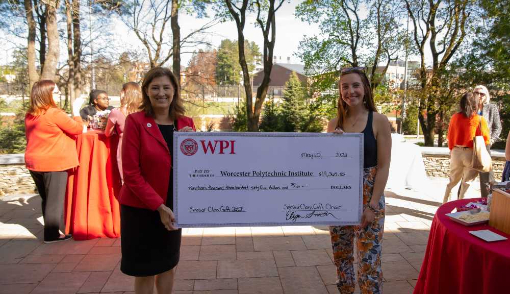Laurie Leshin poses with a member of the Senior Class Gift committee, both of them holding an oversized check.