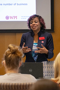 Priest. Debora Jackson, Dean of the WPI School of Business, in front of a group of students