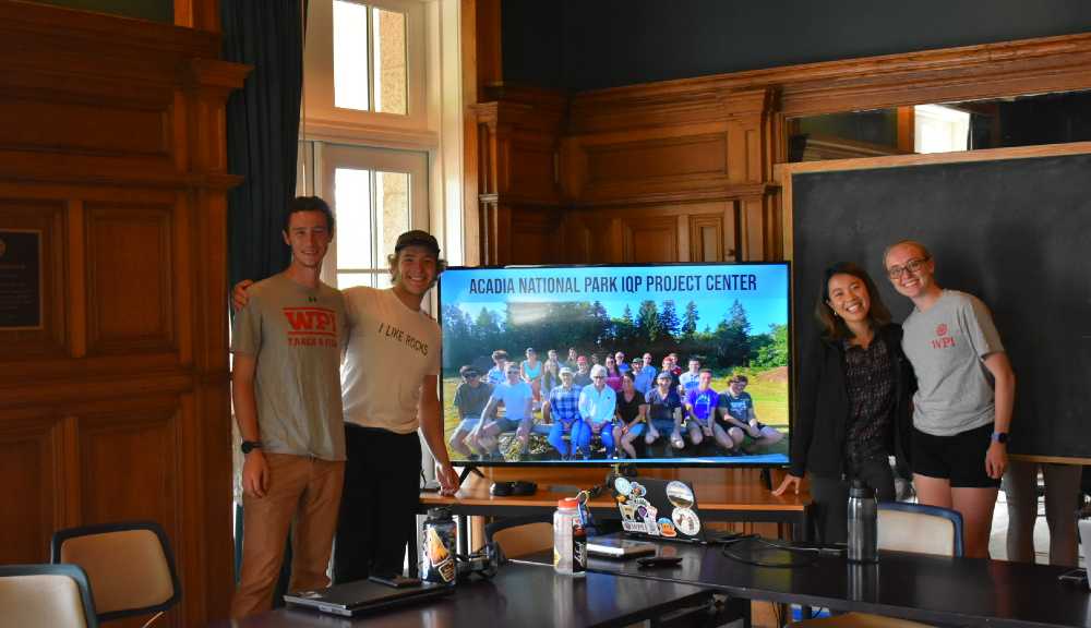 Students smile together after presenting their work at Acadia National Park.