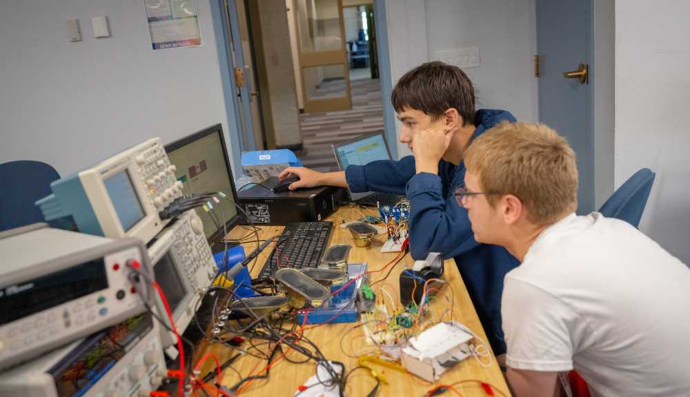 Two students work on a computer project during Frontiers.
