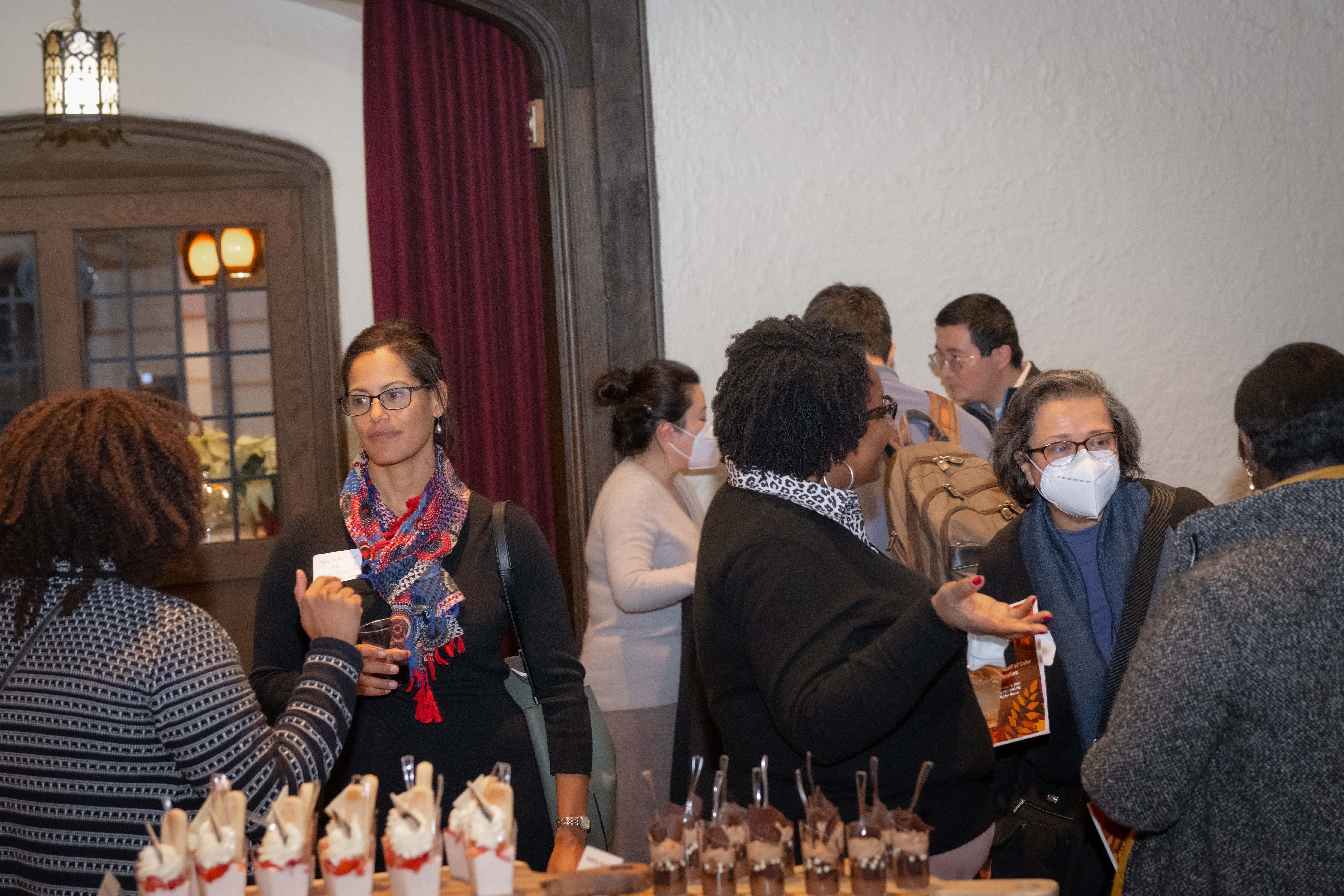 Faculty and staff gather for conversation.