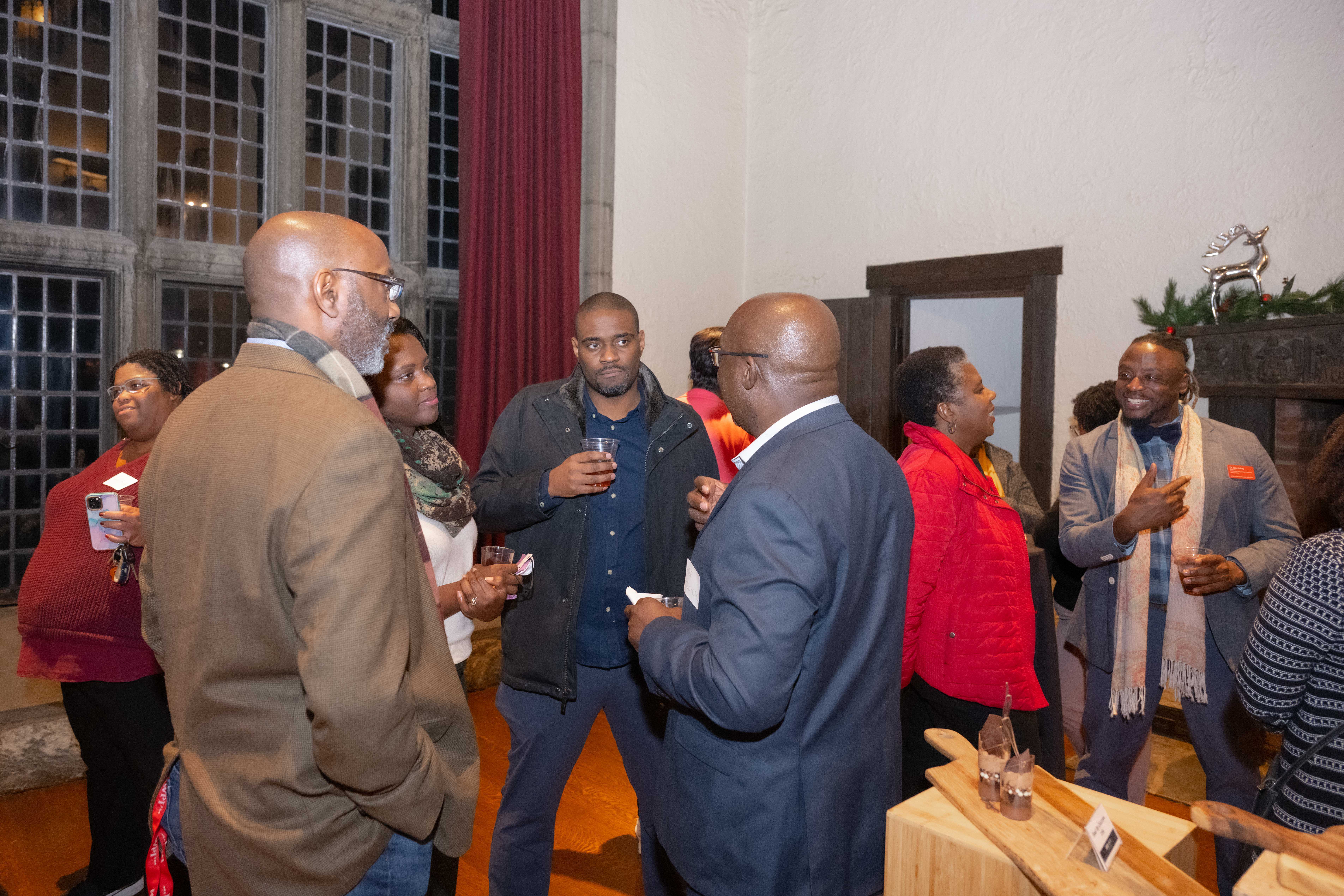 Faculty and staff gather for conversation.