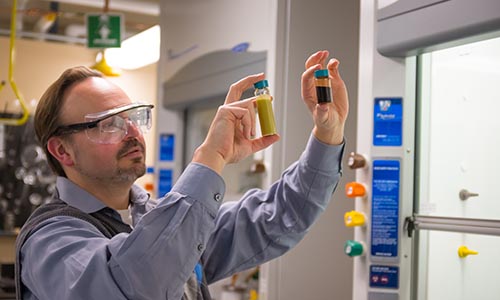 WPI researcher Mike Timko holding vials