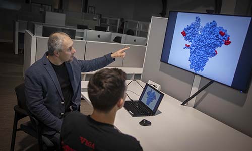 Dmitry Korkin shares a photo of a coronavirus model with a student.