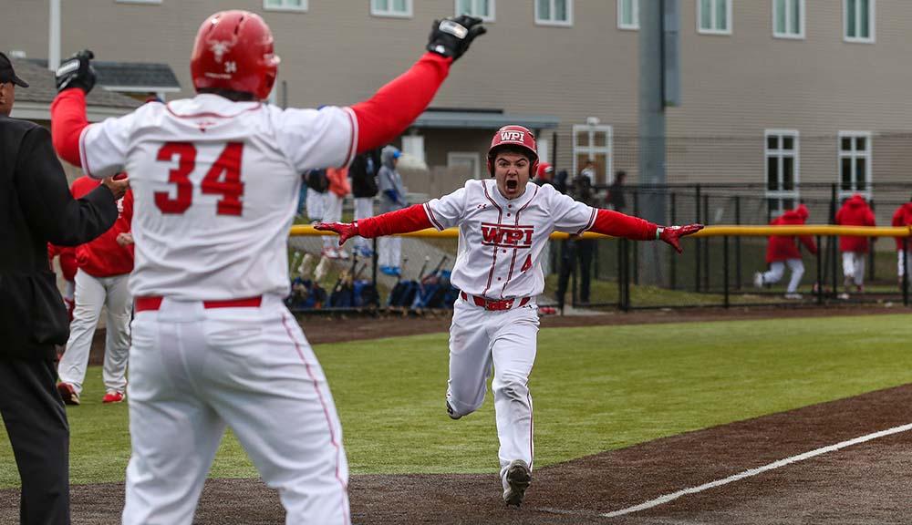 A baseball player desperately running for home base