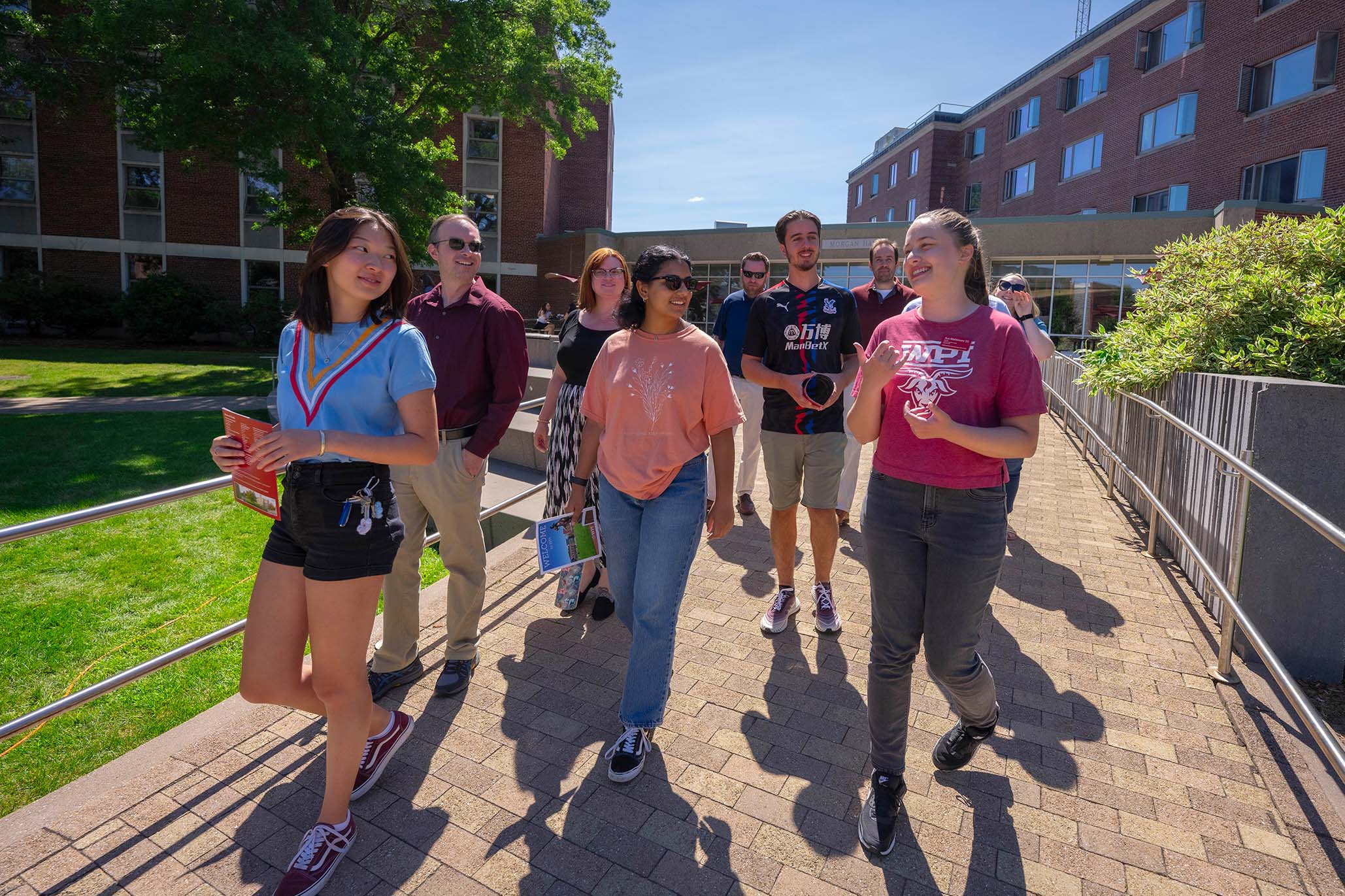 Happy group of people walking on WPI Campus